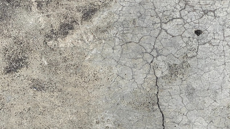 Concrete slab with numerous cracks.