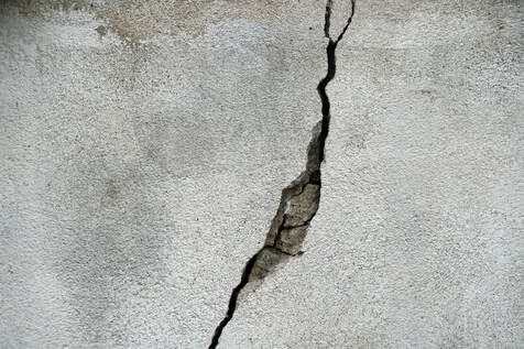 Close up of concrete with a large crack.