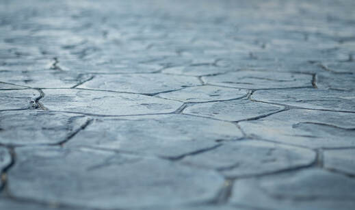 Closeup of gray stamped concrete.